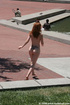 Stunning red head proudly shows her nude body in public square
