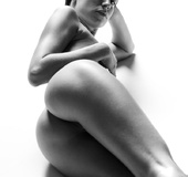 Brunette babe with a braid posing naked fro black-and-white pics