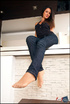 Beautiful seductress bewitches with her big feet in sexy tan nylon socks