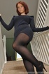 Pretty ginger MILF in tights and high heels undresses on stirs to expose