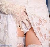 Lovely blonde babe in bride's dress and gloves fingering her twat
