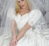 Blonde bride in a dress and stockings toying her cunt before her wedding