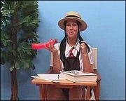 Brunette chick in a school uniform and a hat playing with a vibro