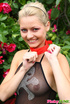 Sexy naughty blonde in pretty red and black dress enjoys looking sexy