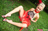 Sexy naughty blonde in pretty red and black dress enjoys looking sexy