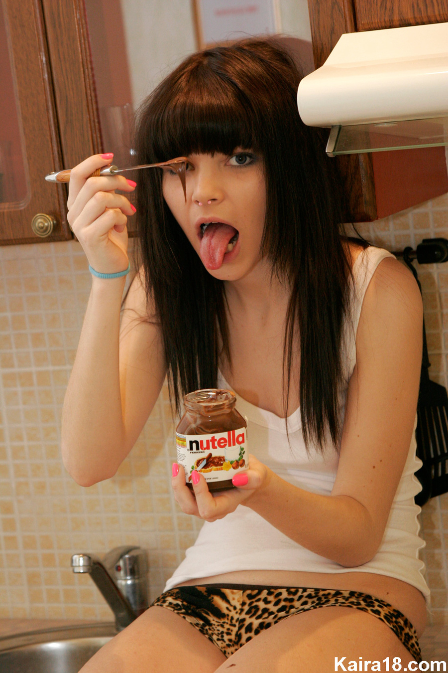 Making erotic fun with Nutella when sizzling teen discovers it in kitchen.  Picture 3.