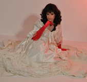 Sexy male chick with red gloves drops white gown to reveal sexiness