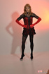 Sexy male chick combines red and black dress with pantyhose and boots