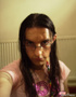 Bored male chick in glasses shows smooth ass and takes sexy photos