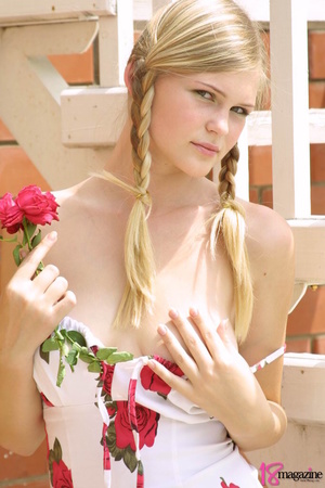 A gorgeous blond with red rose undressed topless in her red roses printed dress - Picture 4