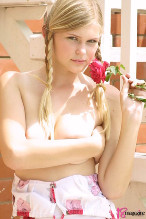 A gorgeous blond with red rose undressed topless in her red roses printed dress - Picture 10