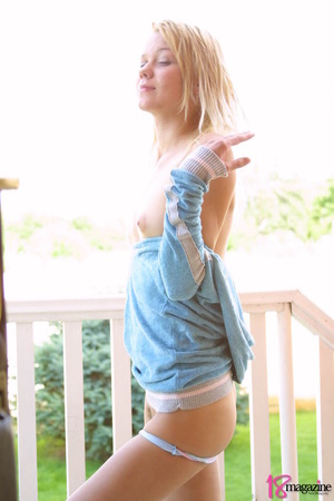 An adoring sexy blondie in lightblue tops goes topless for seductive poses - Picture 8