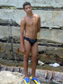A robust young bronze latino sunbathing among the rocks and wanking that
