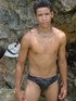 A robust young bronze latino sunbathing among the rocks and wanking that