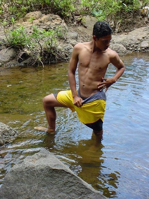 A lewd latino twink takes a dip in the shallow waters of the brook and there jerks himself off in the water until he cums - Picture 1