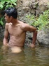 A lewd latino twink takes a dip in the shallow waters of the brook and