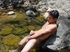 A lewd latino twink takes a dip in the shallow waters of the brook and