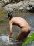 A lewd latino twink takes a dip in the shallow waters of the brook and