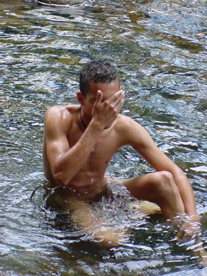 A bronzed lusty latino plays naked in the waters of a brook showing how to manipulate his nice thick cock - Picture 2