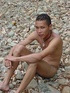 A bronzed lusty latino plays naked in the waters of a brook showing how