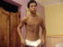 A bronzed lusty latino plays naked in the bed covers showing how to manipulate