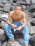 A lusty bronzed latino twink poses nude for the camera showing the extra