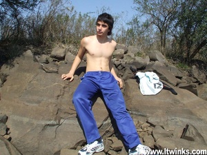A fair skinned latino twink sunbathes on the rocks and poses his deliciously huge cock and plays with it - XXXonXXX - Pic 1