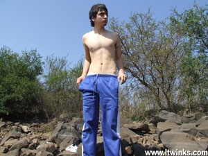 A fair skinned latino twink sunbathes on the rocks and poses his deliciously huge cock and plays with it - XXXonXXX - Pic 2