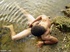 Frolicking in the water is a nude dark skinned horny latino enjoying whacking