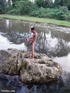 Frolicking in the water is a nude dark skinned horny latino enjoying whacking