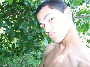 A dark randy latino twink proudly showing his huge equally dark dick among the bushes and blasting cock juice all over his stomach - Picture 8
