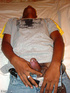 A randy and very dark young latino hunk displays his already heavily aroused