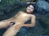 Uncut horny Asian gay gets nude to play in the stream with his cock to