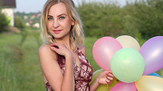 Slutty blonde gal with balloons takes off her clothes to present her big jugs