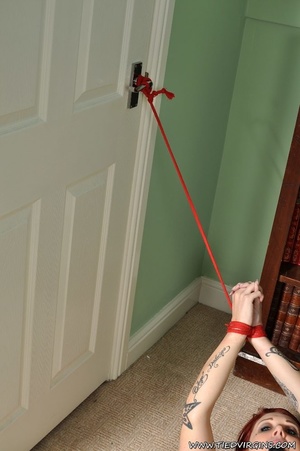 Fiery haired slutty submissive gets to be tethered to the door while trying to escape bondage - Picture 4