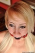 Lusty blonde bimbo gets to be bound on a chair, ball gagged and enjoying