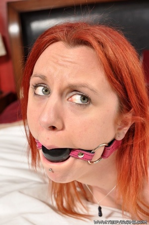 Red haired virgin bitch struggles helplessly against being cross tied on the bed and being ball gagged - Picture 12