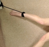 Very naked red haired beauty is on the floor bound to spread eagle to