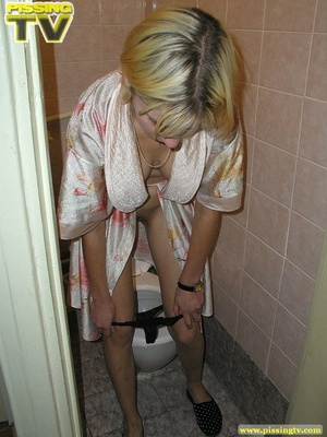 A slutty blonde bitch demonstrates how enjoyable  taking a piss in the toilet can be - Picture 18