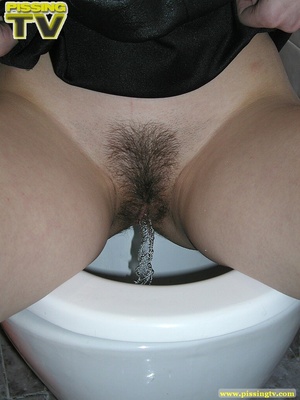 Lusty brunette takes her turn in sitting on the toilet throne and releases a generous gushing of heavenly pee into the bowl - Picture 7