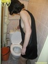 Lusty brunette takes her turn in sitting on the toilet throne and releases