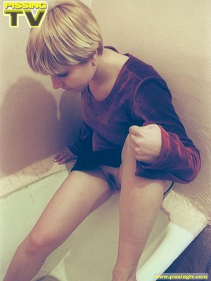 Short haired blonde teen slut goes to the bath for a rather exciting pissing opportunity where she relieves herself of her warm golden pee in the bath - Picture 5