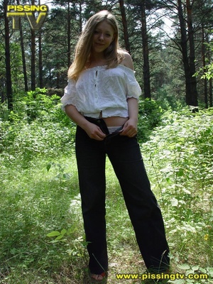 Horny blonde teen pulls down her pants in the forest then takes a glorious piss among the grasses with tips of weeds tickling her ass and pussy - Picture 3