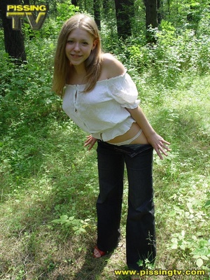 Horny blonde teen pulls down her pants in the forest then takes a glorious piss among the grasses with tips of weeds tickling her ass and pussy - Picture 4