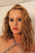 Blonde nude with chain restaints is made to piss into a tub filled with