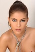 Naked brunette beauty is chained and squatted over a piece of cloth then