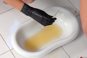 Lusty bitch in a tight leather dress makes naked blonde take a piss over a bed pan then takes sample of piss and tests it with litmus paper that changes color - Picture 10