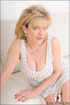 Lovely sexy unfaithful wife playfully teases in a white dress and white