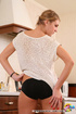 Blonde chick in ponytail posing in panties and socks in the kitchen