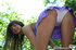 Teen cutie in a short skirt posing outdoors